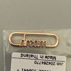 NWT Pandora 14KT plate rose gold dream script charm.